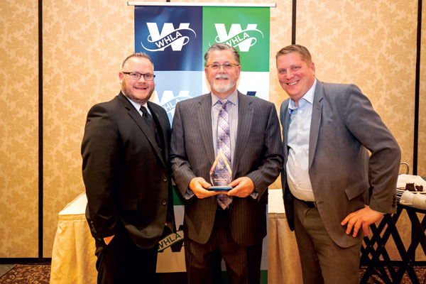 Jay Schumerth receiving the 2022 Corporate Champion Award, standing next to Brandon McConnell (WHLA Board Chair) and Bill Elliott (WHLA President & CEO)