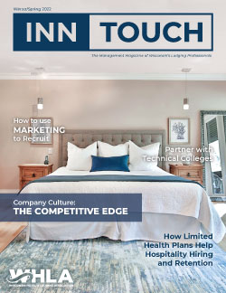 InnTouch Winter/Spring 2022 Cover. Image of plush bed with white comforter, blue blanket, lots of white and blue pillows, and a grey fabric headboard. Article headlines listed.