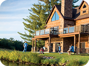 The Dells. Lake Delton Waterfront Villas, Lake Delton, WI. Exterior property photo with a family playing catch in the yard.