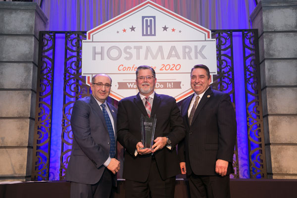 Jay Schumerth winning an award at the Hostmark Conference 2020
