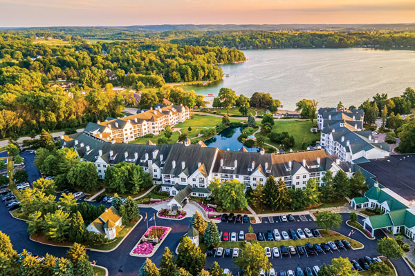 The Osthoff Resort (Elkhart Lake, WI) aerial view featuring the resort and the lake in the background