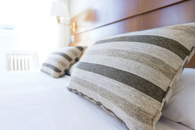 Pillows laying on a hotel bed