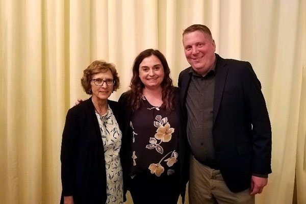 Trisha Pugal, Monica Goeke, and Bill Elliott posing for a picture at the 2022 ISHA Conference and celebrating Monica's achievement