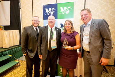 Carmen Smalley receiving the 2022 Associate of the Year Award. Standing next to Brandon McConnell (WHLA Board Chair), Jay Jones (2021 Associate of the Year), and Bill Elliott (WHLA President & CEO)